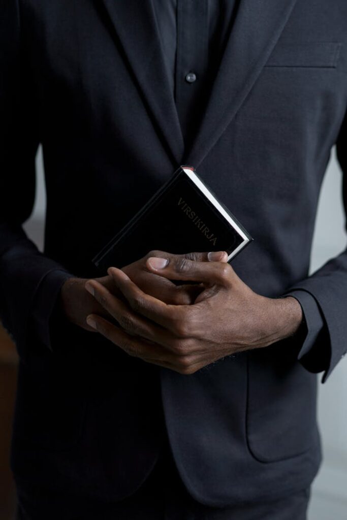 Close-up of hands holding a religious book, symbolizing faith and spirituality.